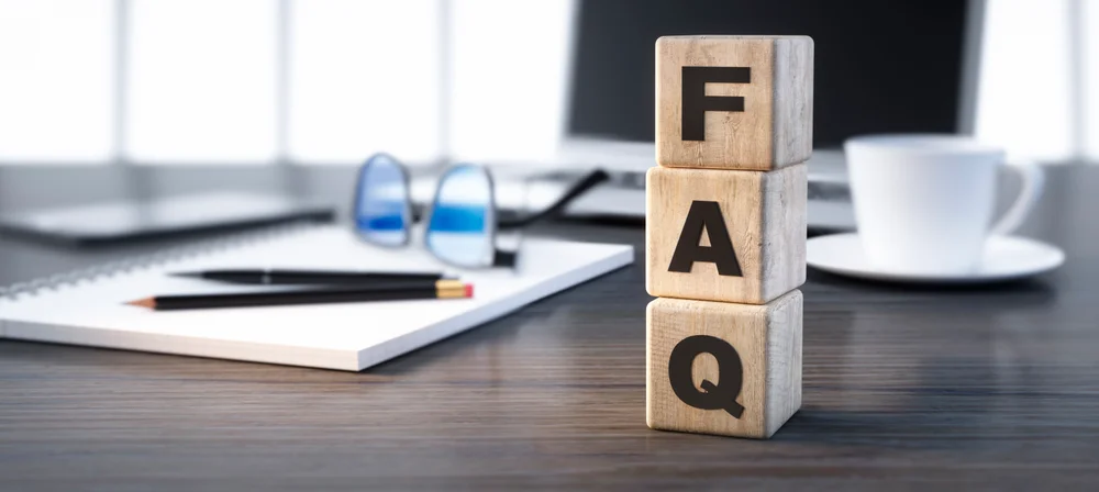 Wooden blocks spelling FAQ on a desk